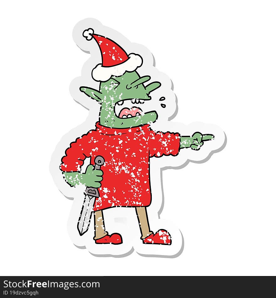 Distressed Sticker Cartoon Of A Goblin With Knife Wearing Santa Hat