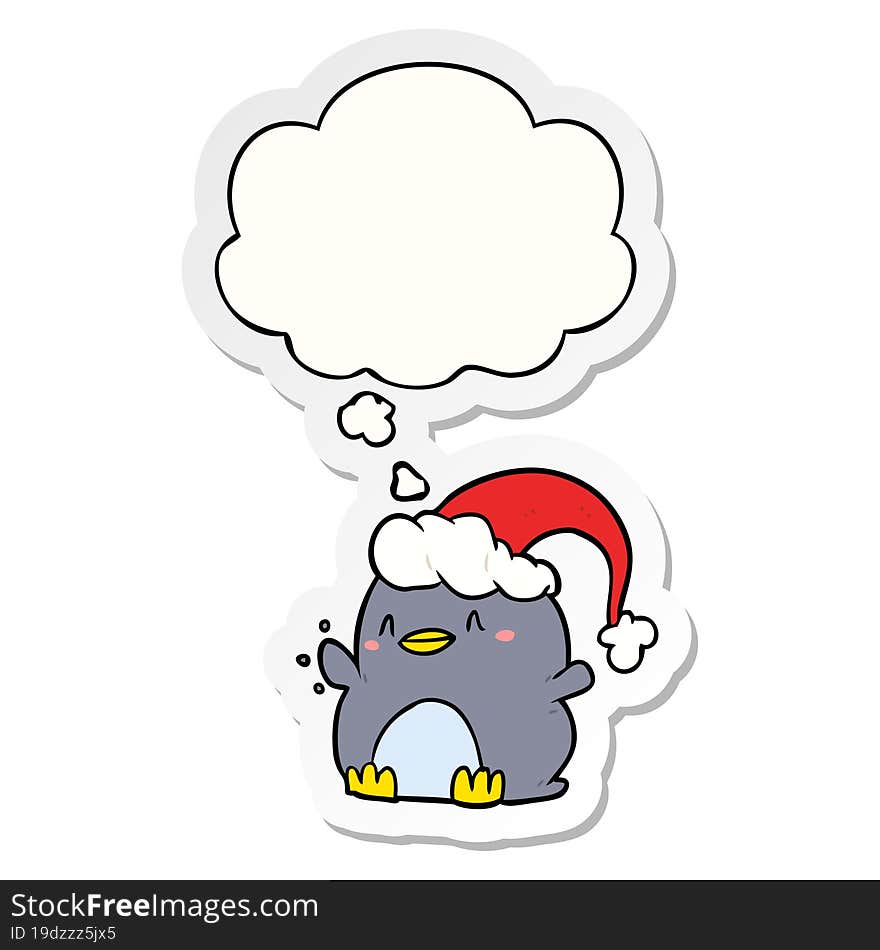 cartoon penguin wearing christmas hat and thought bubble as a printed sticker