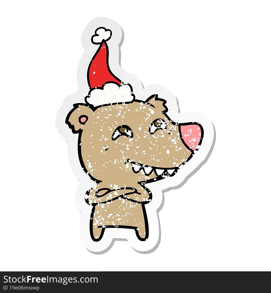 distressed sticker cartoon of a bear showing teeth wearing santa hat