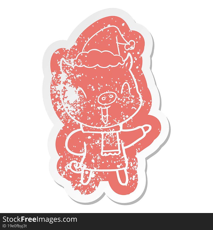 happy cartoon distressed sticker of a pig in winter clothes wearing santa hat