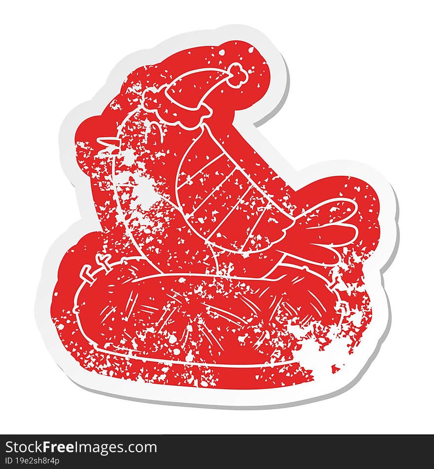 Cartoon Distressed Sticker Of A Bird Sitting On Nest Wearing Santa Hat