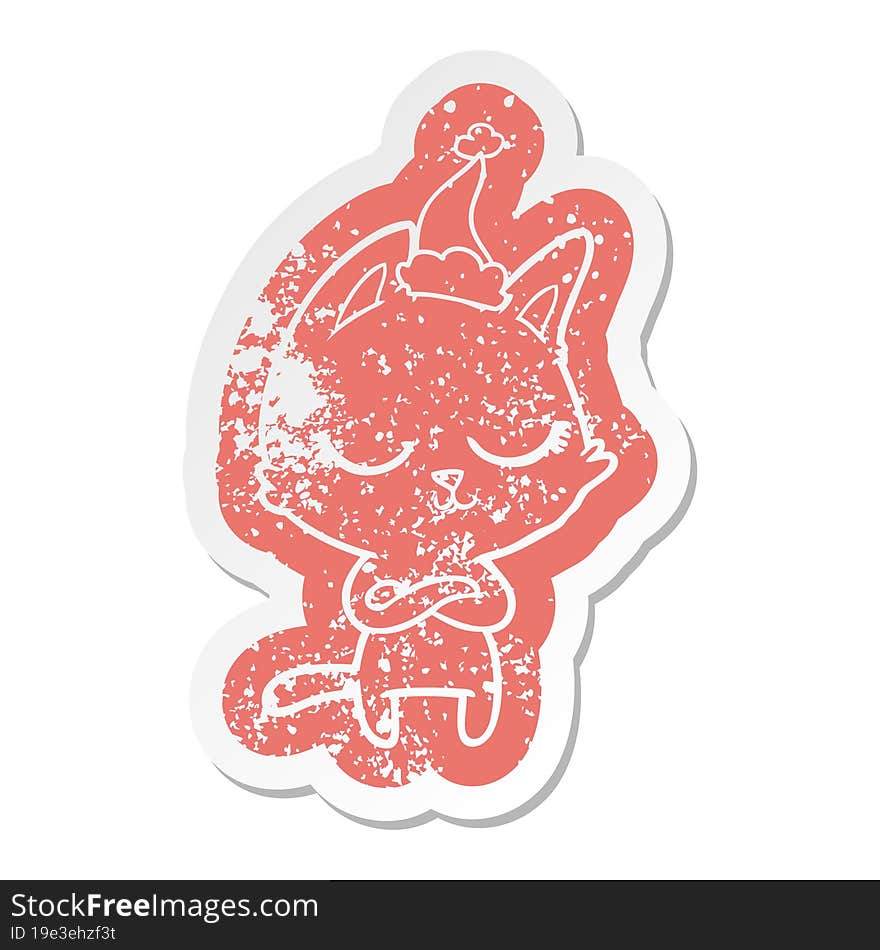 calm cartoon distressed sticker of a cat wearing santa hat