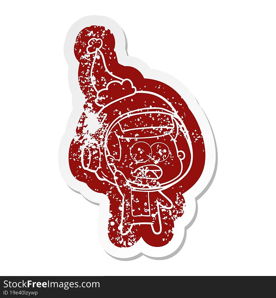 Cartoon Distressed Sticker Of A Surprised Astronaut Wearing Santa Hat