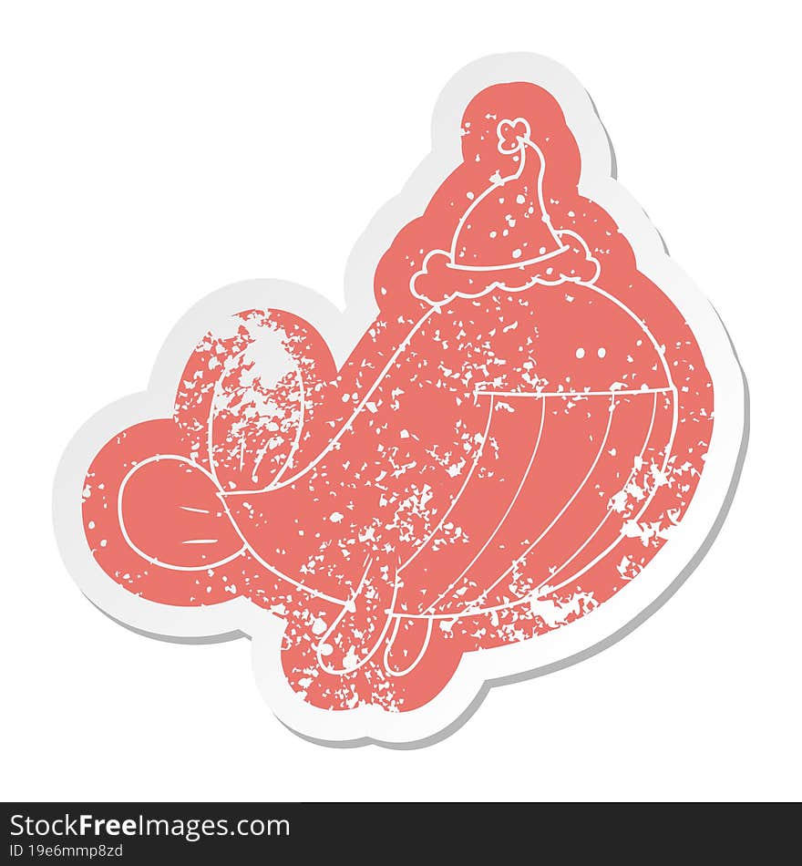 cartoon distressed sticker of a whale wearing santa hat