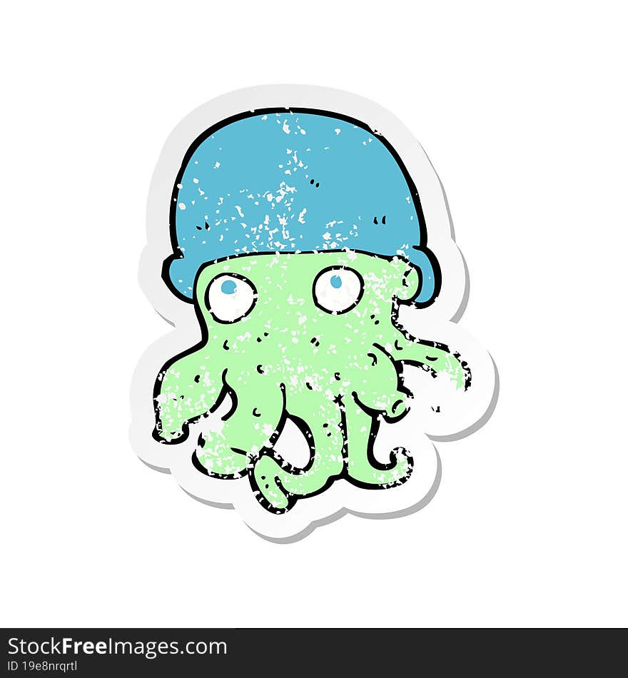 Retro Distressed Sticker Of A Cartoon Alien Head Wearing Hat