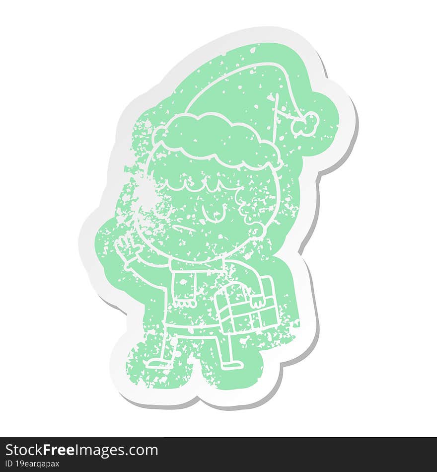 quirky cartoon distressed sticker of a grumpy boy wearing santa hat