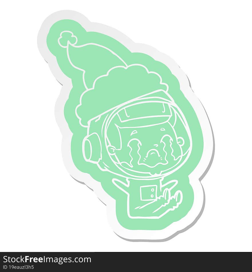 cartoon  sticker of a crying astronaut wearing santa hat