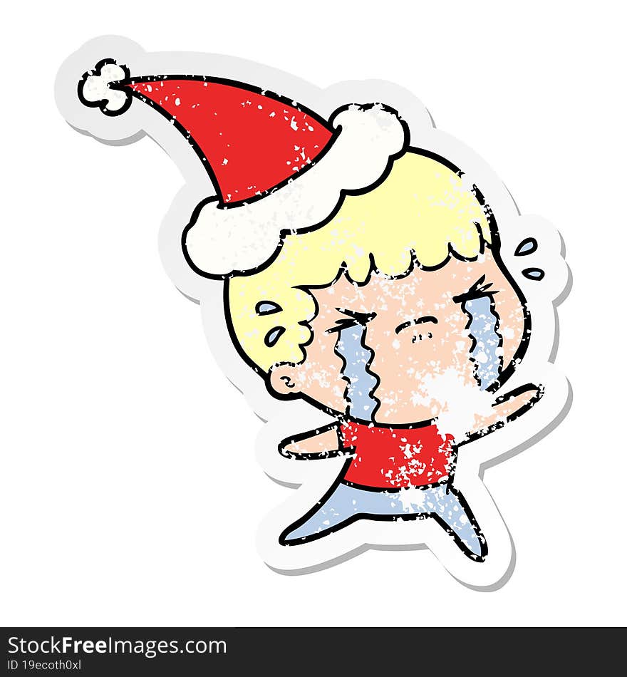 distressed sticker cartoon of a man crying wearing santa hat