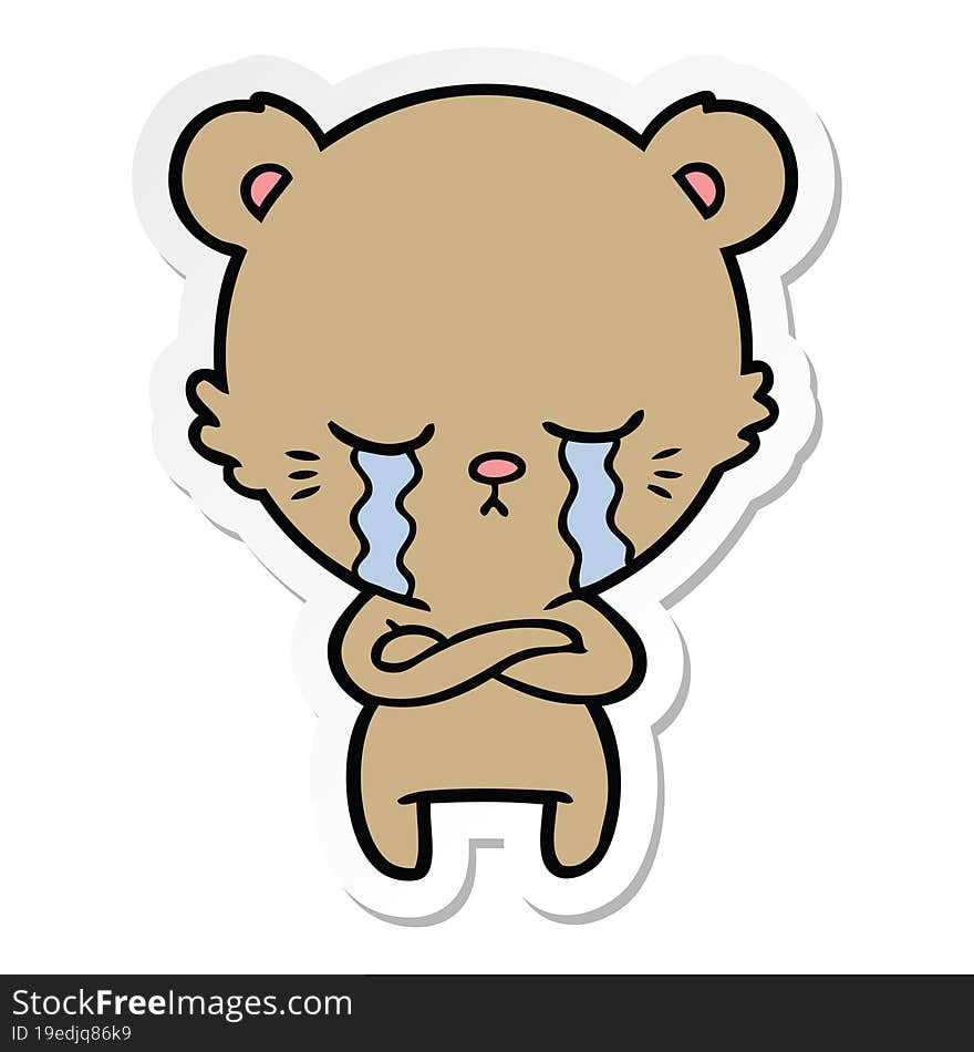 sticker of a crying cartoon bear with folded arms