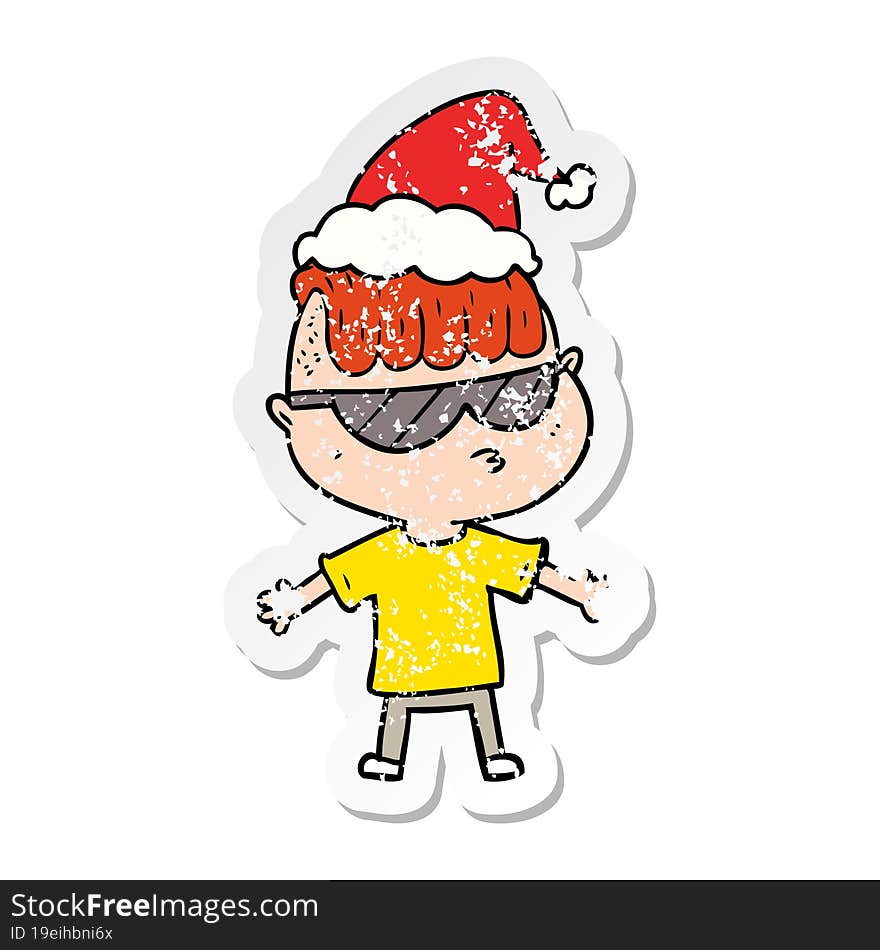 distressed sticker cartoon of a boy wearing sunglasses wearing santa hat