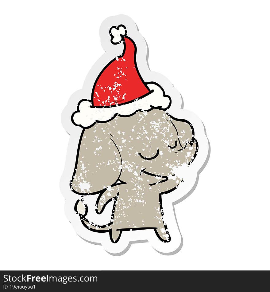 distressed sticker cartoon of a smiling elephant wearing santa hat