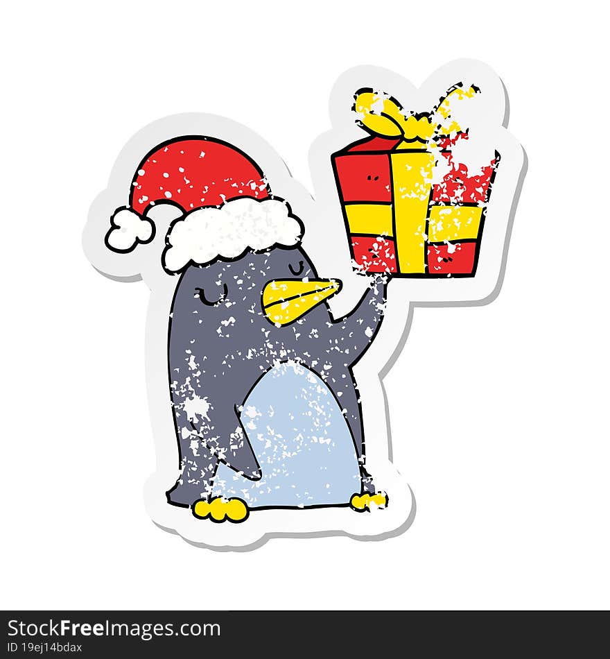 Distressed Sticker Of A Cartoon Penguin With Christmas Present