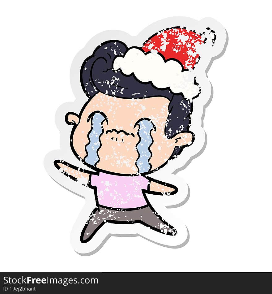 distressed sticker cartoon of a man crying wearing santa hat