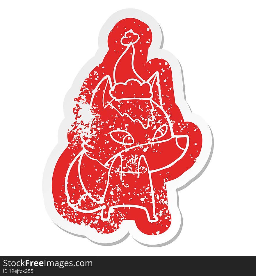 Shy Cartoon Distressed Sticker Of A Wolf Wearing Santa Hat