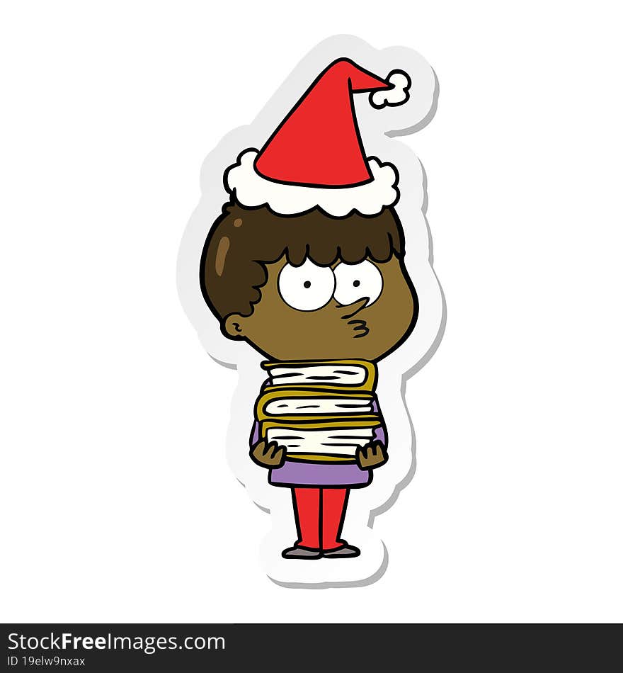 sticker cartoon of a curious boy with lots of books wearing santa hat