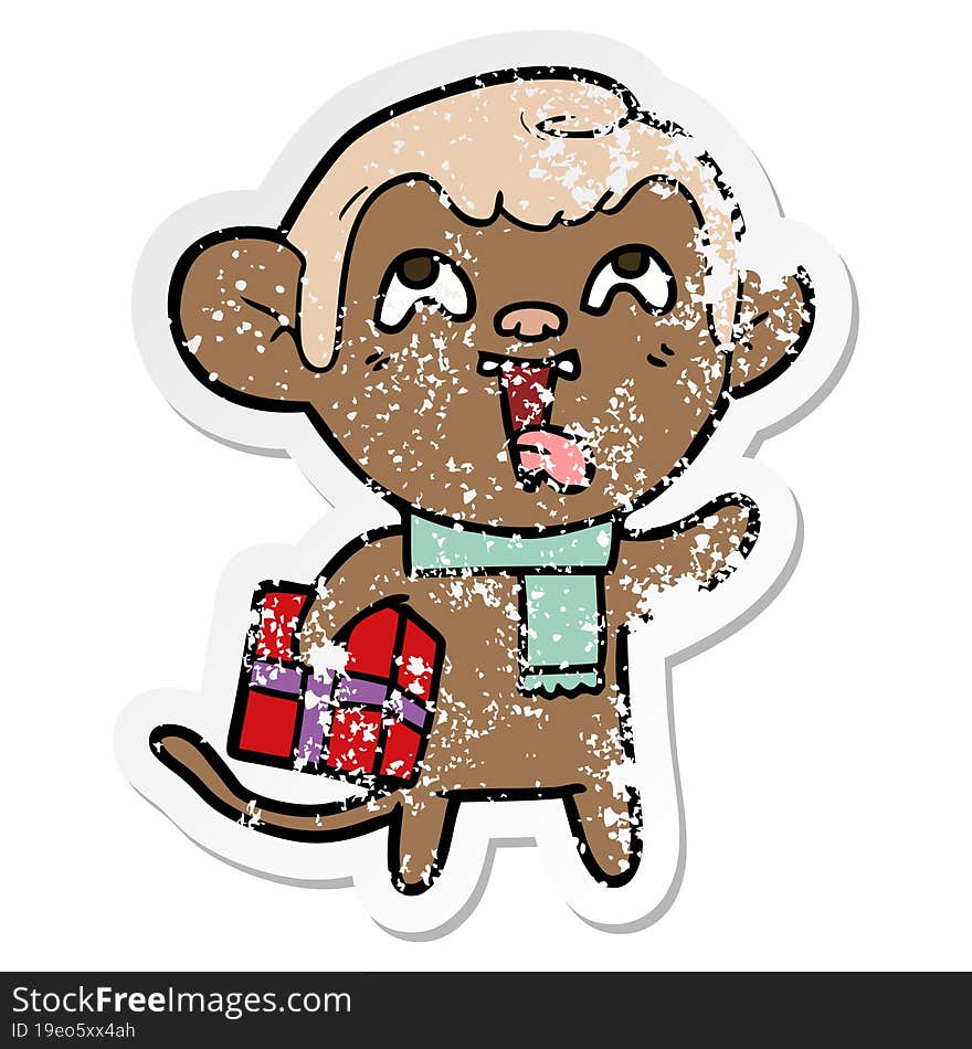 Distressed Sticker Of A Crazy Cartoon Monkey With Christmas Present