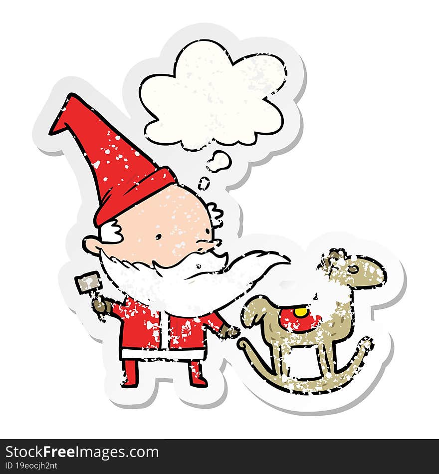 cartoon santa making toy with thought bubble as a distressed worn sticker