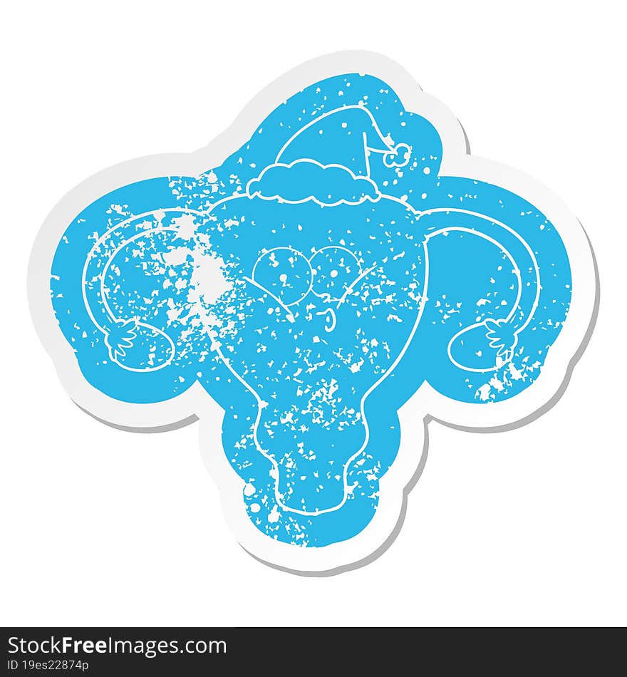 quirky cartoon distressed sticker of a uterus wearing santa hat