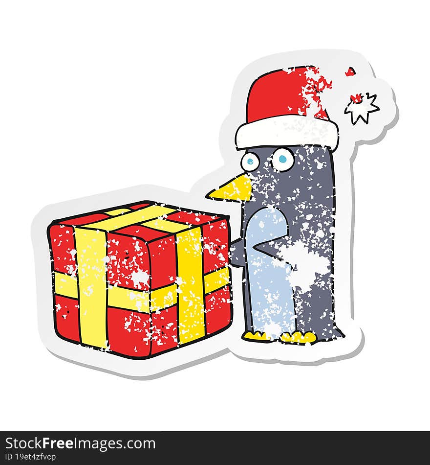 retro distressed sticker of a cartoon christmas penguin with present