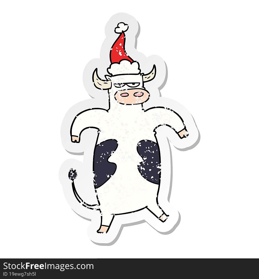 hand drawn distressed sticker cartoon of a bull wearing santa hat