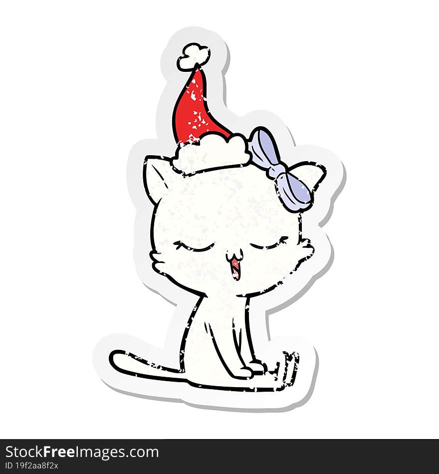 hand drawn distressed sticker cartoon of a cat with bow on head wearing santa hat