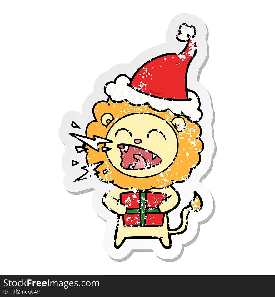 distressed sticker cartoon of a roaring lion with gift wearing santa hat