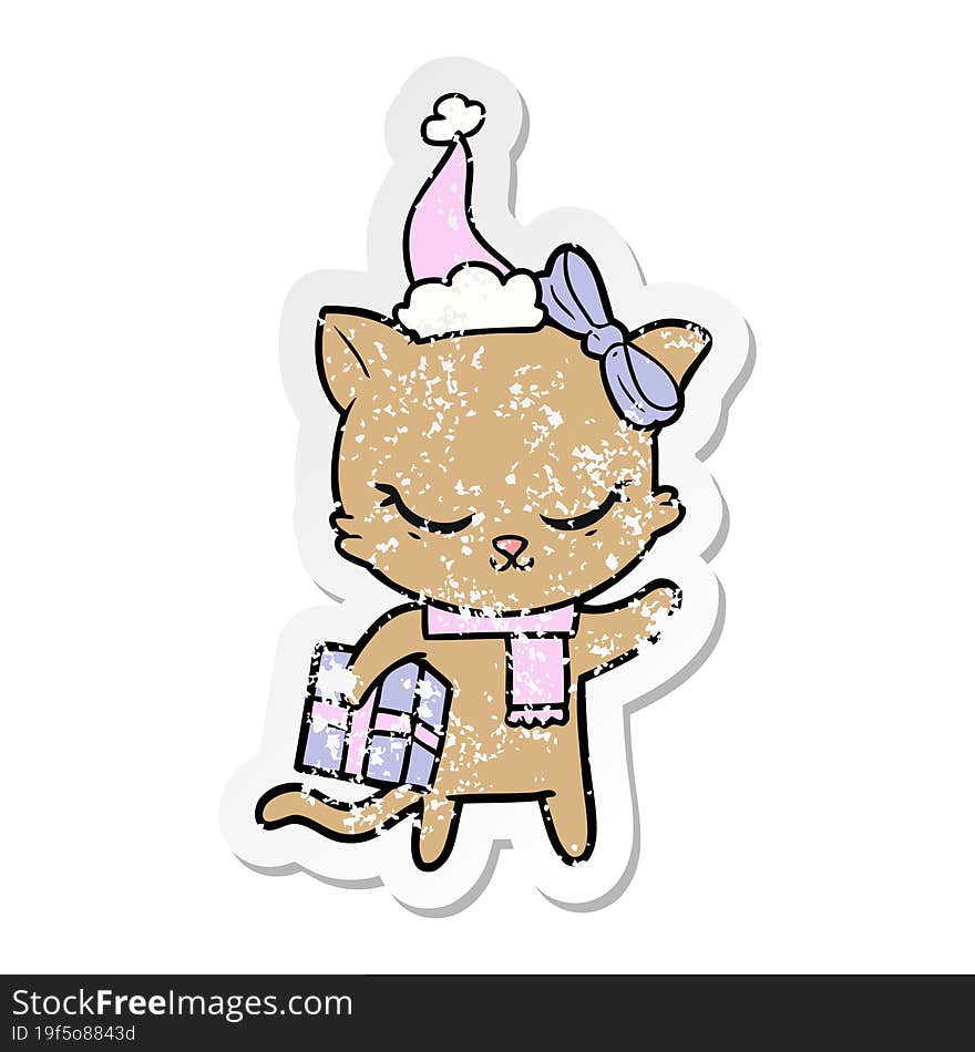 cute hand drawn distressed sticker cartoon of a cat with present wearing santa hat