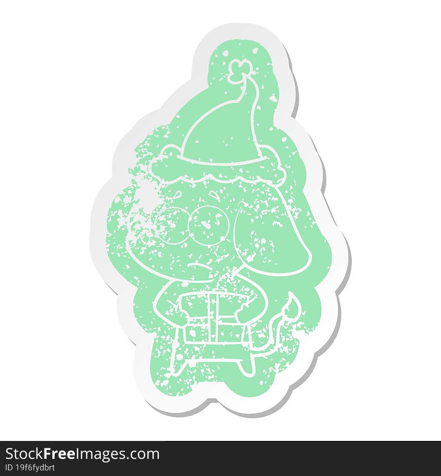 quirky cartoon distressed sticker of a unsure elephant with christmas present wearing santa hat