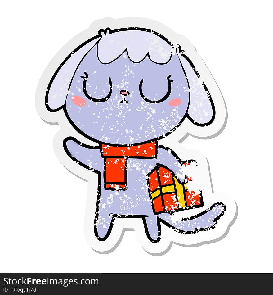 distressed sticker of a cute cartoon dog with christmas present