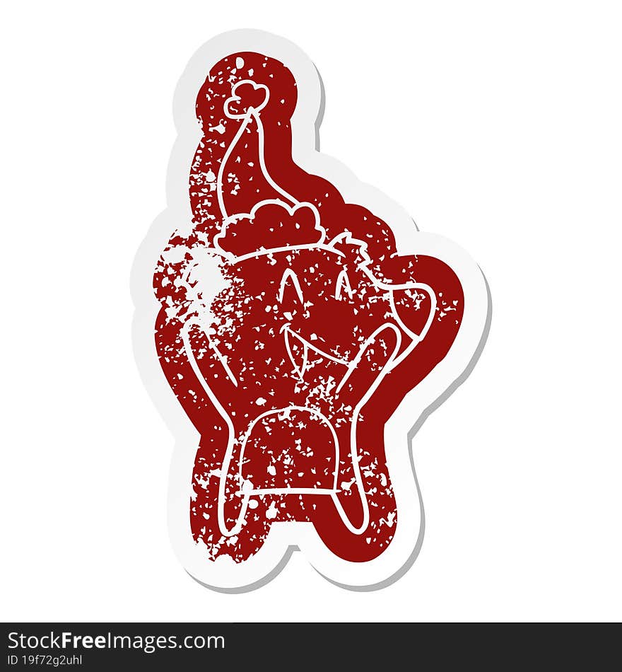 laughing polar bear cartoon distressed sticker of a wearing santa hat