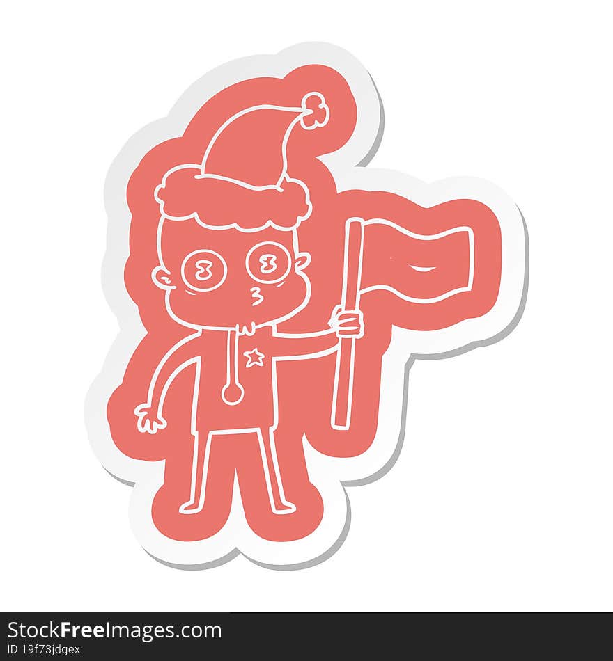 cartoon  sticker of a weird bald spaceman with flag wearing santa hat