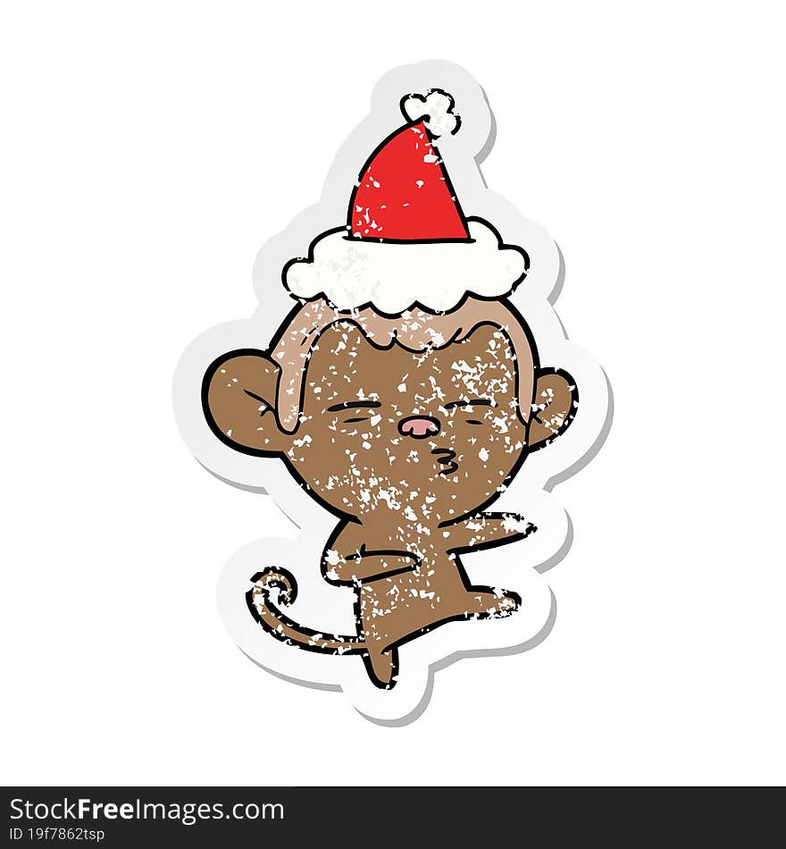 distressed sticker cartoon of a suspicious monkey wearing santa hat