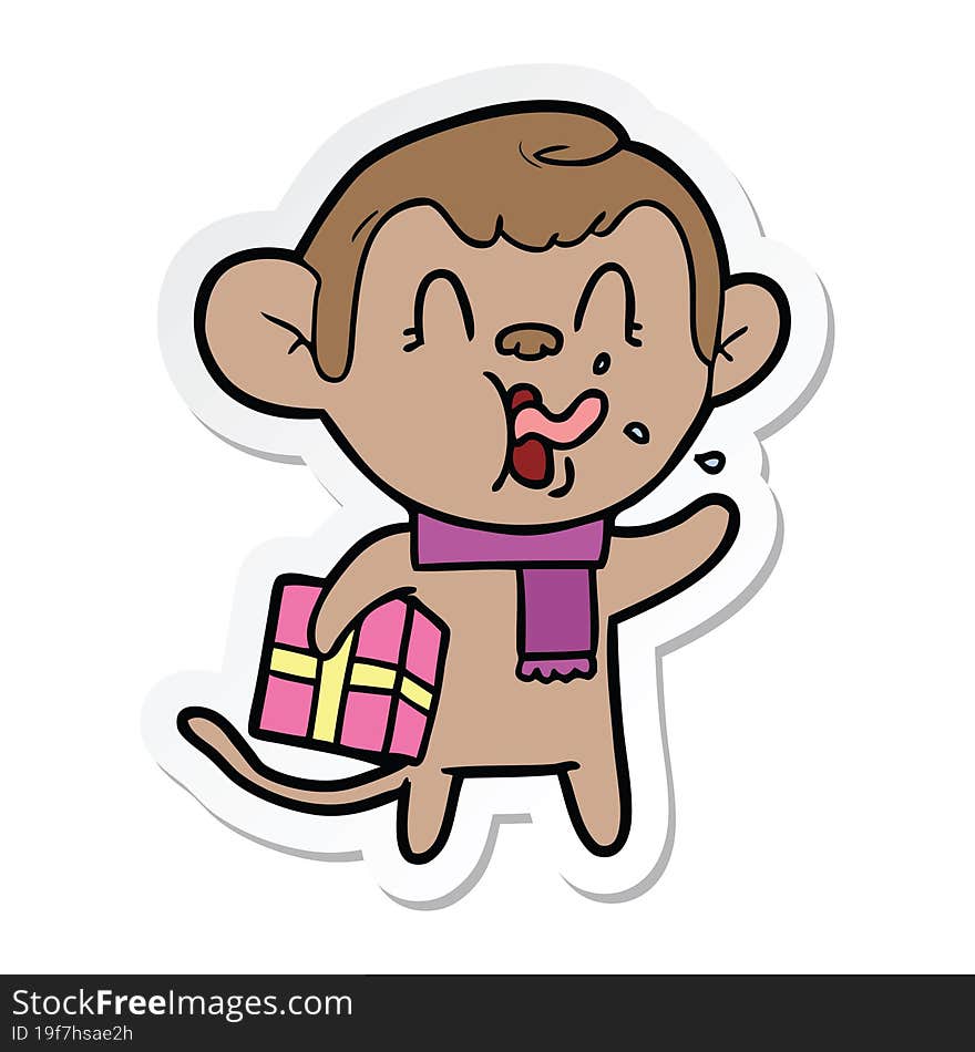 sticker of a crazy cartoon monkey with christmas present