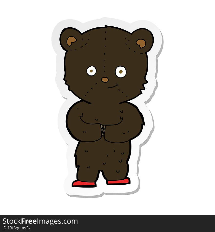 sticker of a cartoon teddy black bear cub