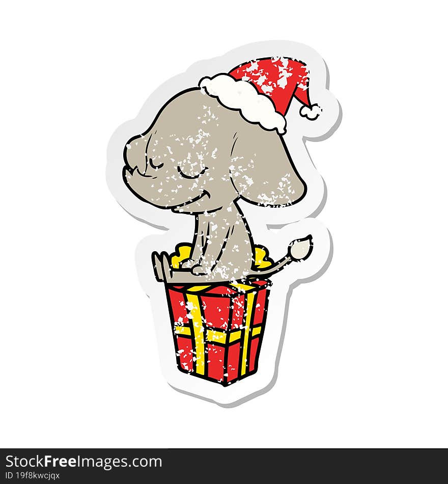 distressed sticker cartoon of a smiling elephant wearing santa hat