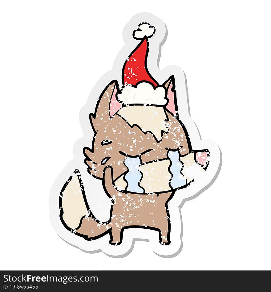 distressed sticker cartoon of a crying wolf wearing santa hat