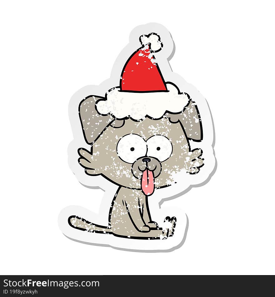 hand drawn distressed sticker cartoon of a sitting dog with tongue sticking out wearing santa hat