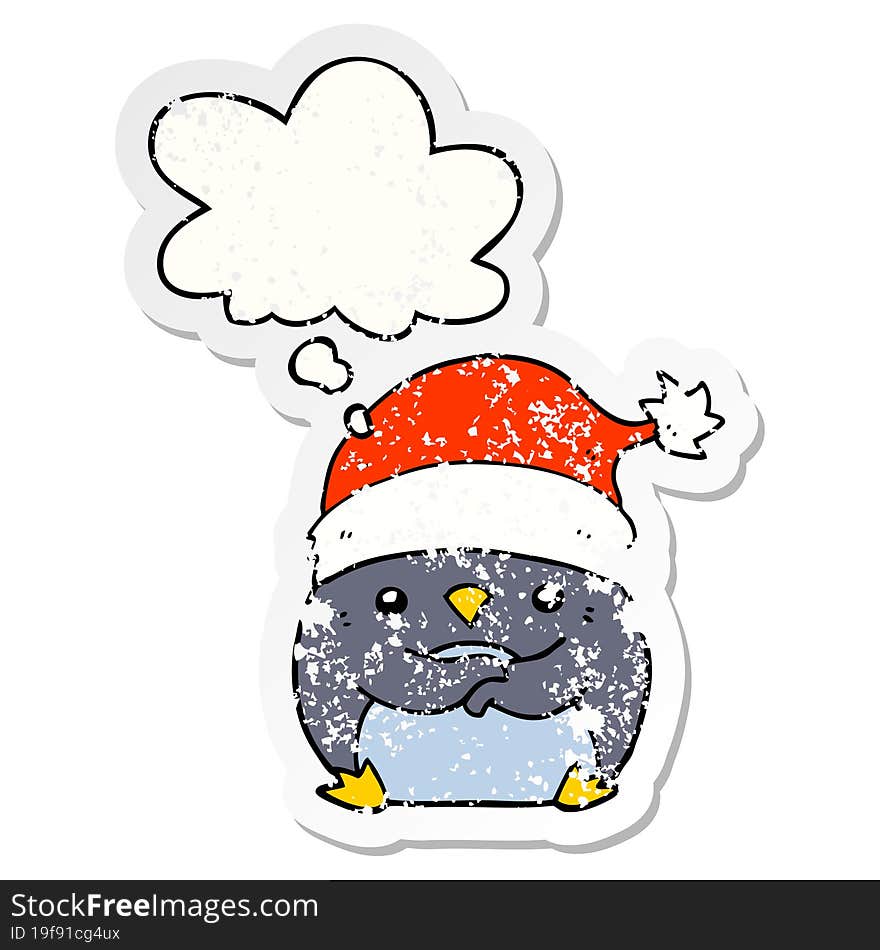 cute cartoon penguin wearing christmas hat and thought bubble as a distressed worn sticker