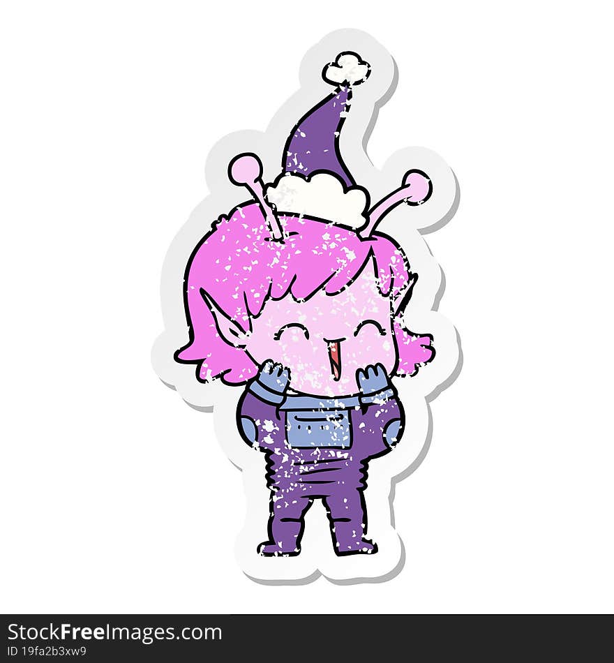 distressed sticker cartoon of a alien girl giggling wearing santa hat