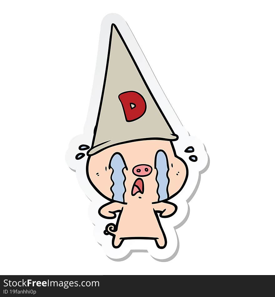 sticker of a crying pig wearing dunce hat