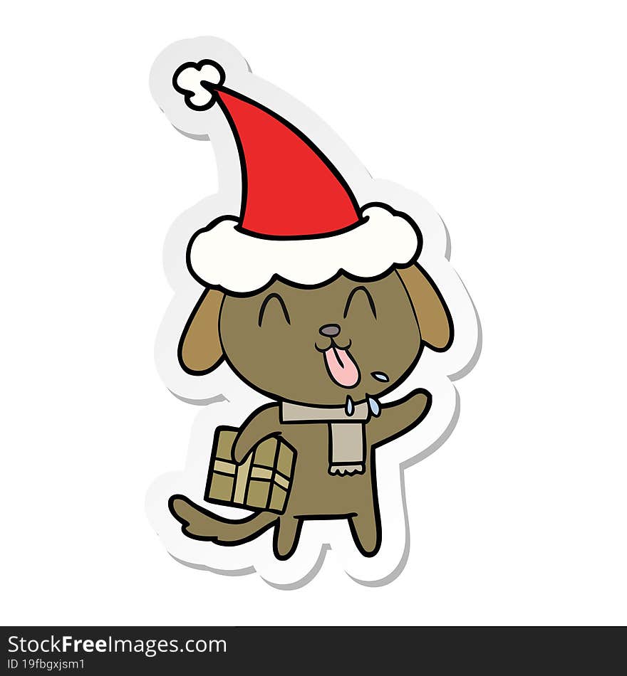 cute sticker cartoon of a dog with christmas present wearing santa hat