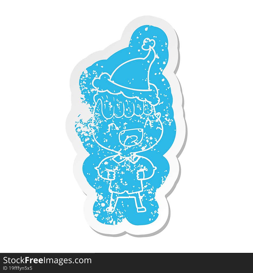 cartoon distressed sticker of a happy boy laughing wearing santa hat