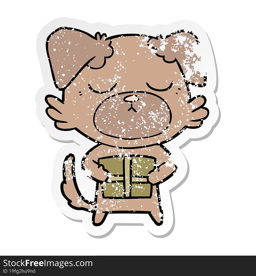 Distressed Sticker Of A Cute Cartoon Dog With Christmas Present