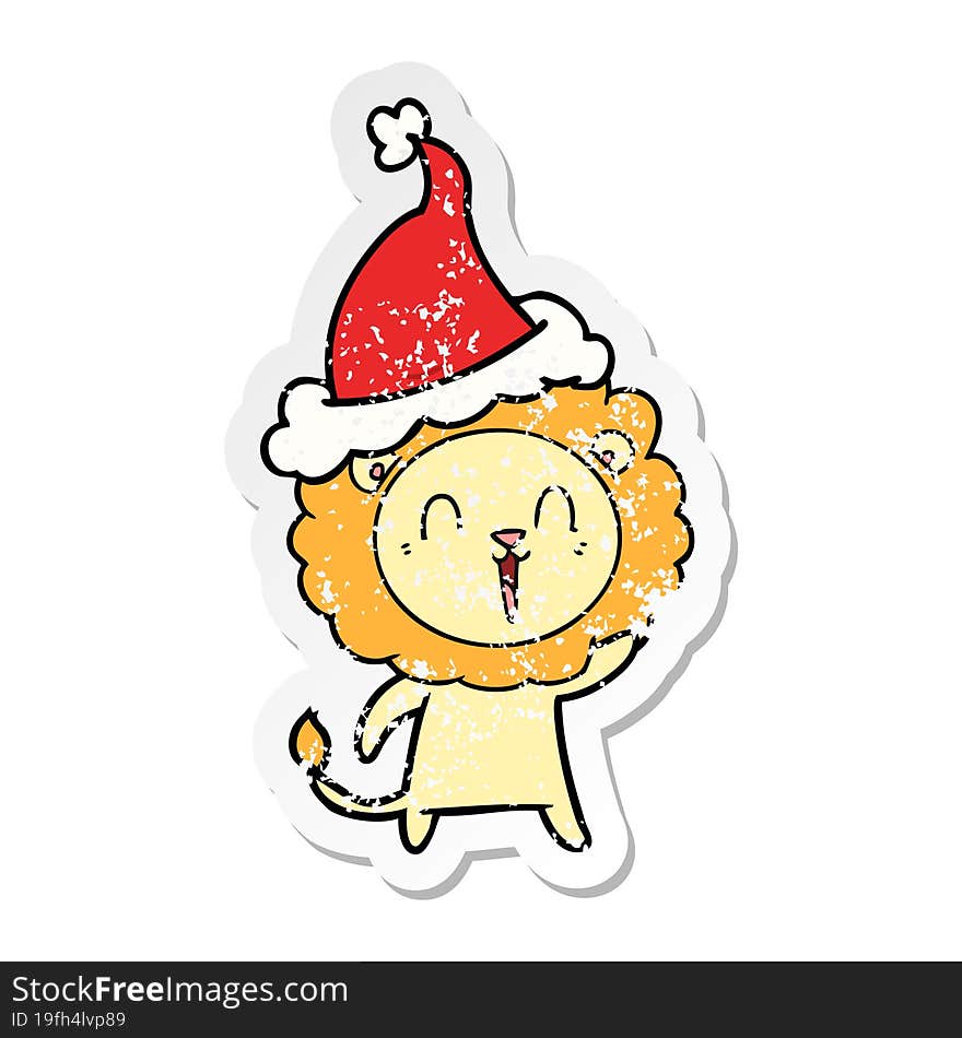 laughing lion distressed sticker cartoon of a wearing santa hat