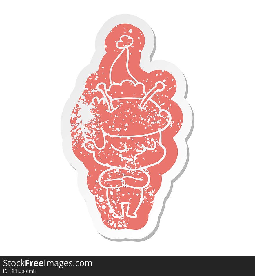 friendly cartoon distressed sticker of a spaceman wearing santa hat