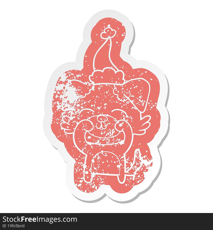 cartoon distressed sticker of a dog wearing santa hat