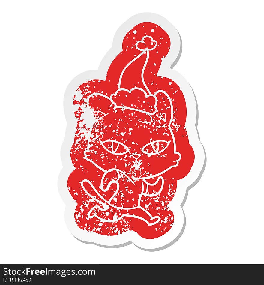 quirky cartoon distressed sticker of a cat out for a run wearing santa hat