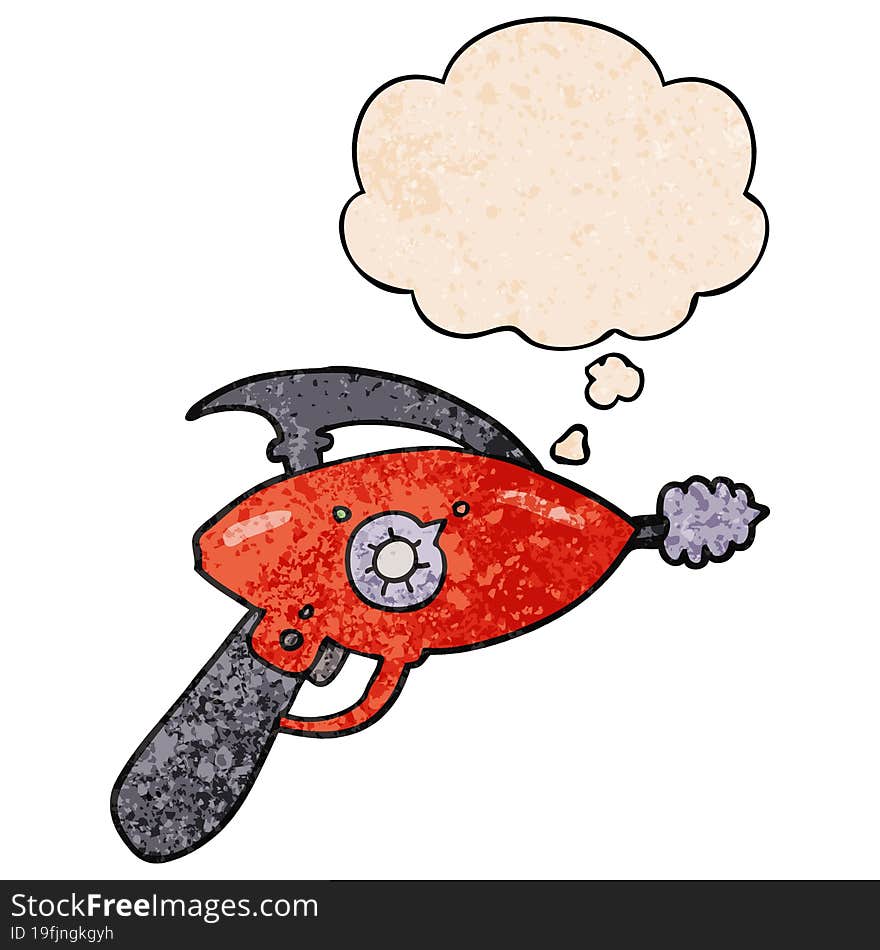 cartoon ray gun and thought bubble in grunge texture pattern style