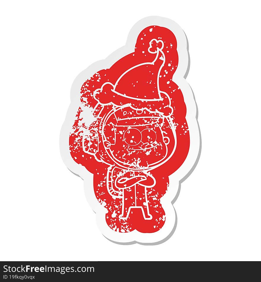 happy astronaut cartoon distressed sticker of a wearing santa hat