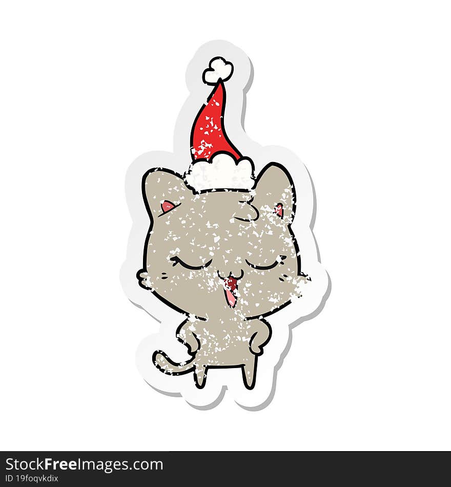 Happy Distressed Sticker Cartoon Of A Cat Wearing Santa Hat